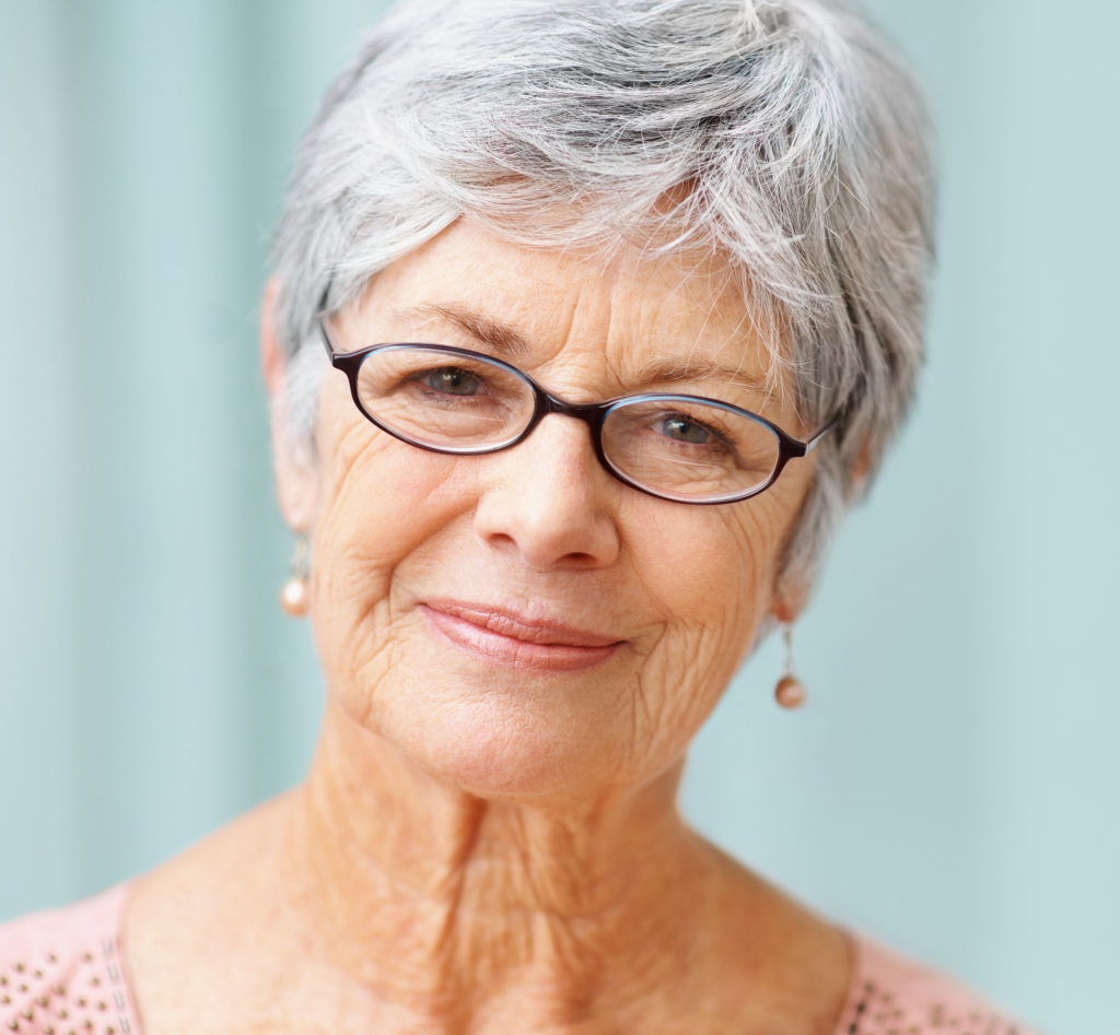 A close up of a woman wearing glasses and earrings