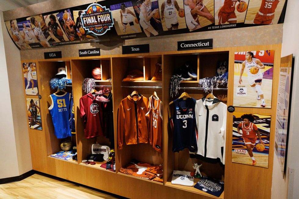 Indoor exhibition booth with colorful posters, hanging lights, and large display banners