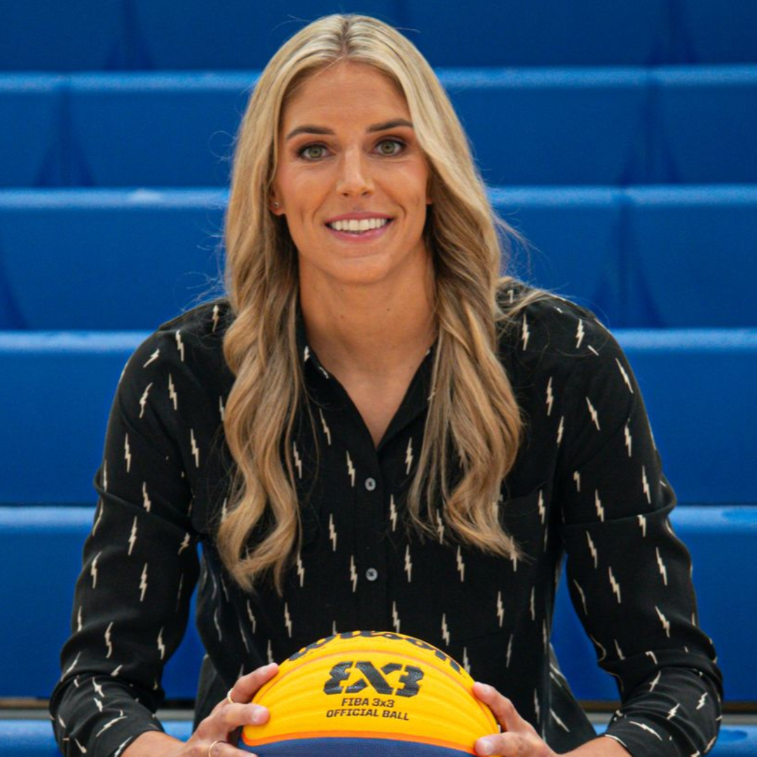 Portrait of a person with long blonde hair, wearing a black shirt on a white background
