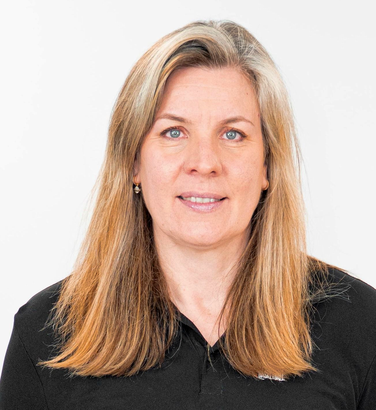Portrait of a person with long blonde hair, wearing a black shirt on a white background