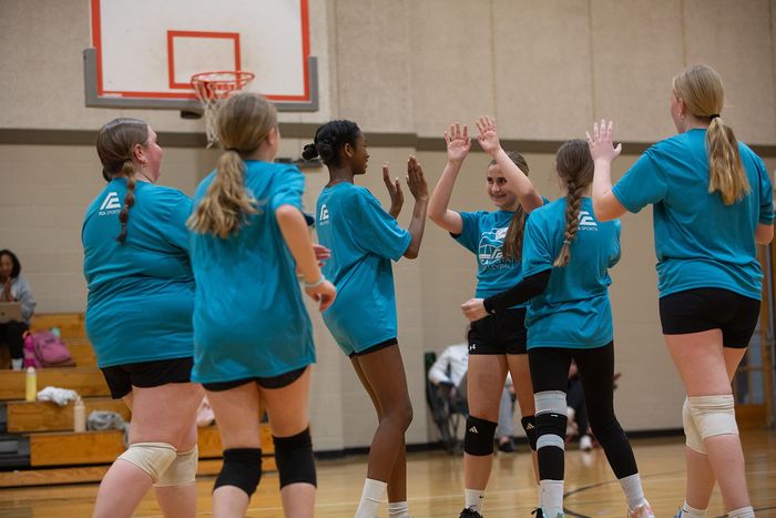 High fives on a volleyball court