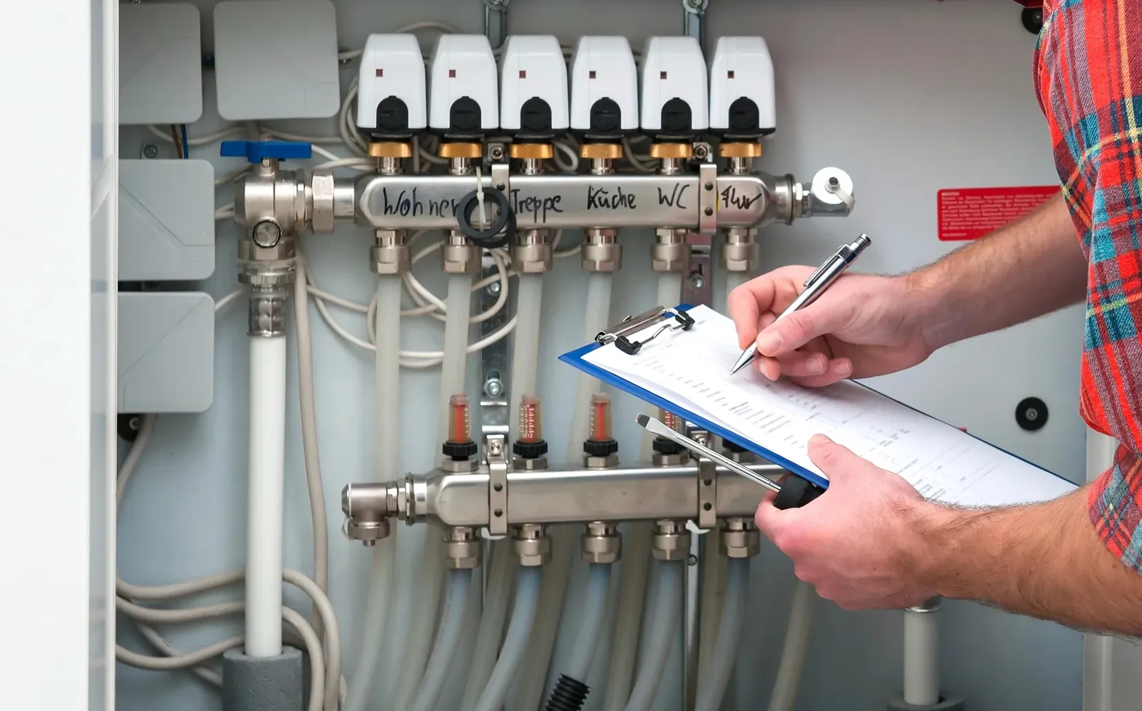 Technician performing preventative maintenance and inspection on a residential heating system.