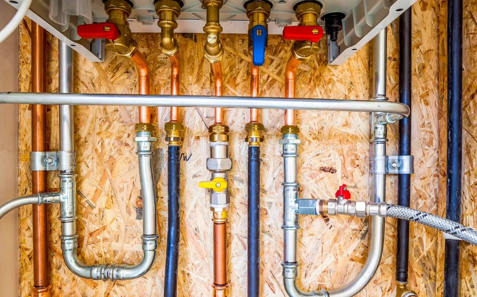 Residential copper repiping system with new water lines, valves and plumbing connections installed inside a home.