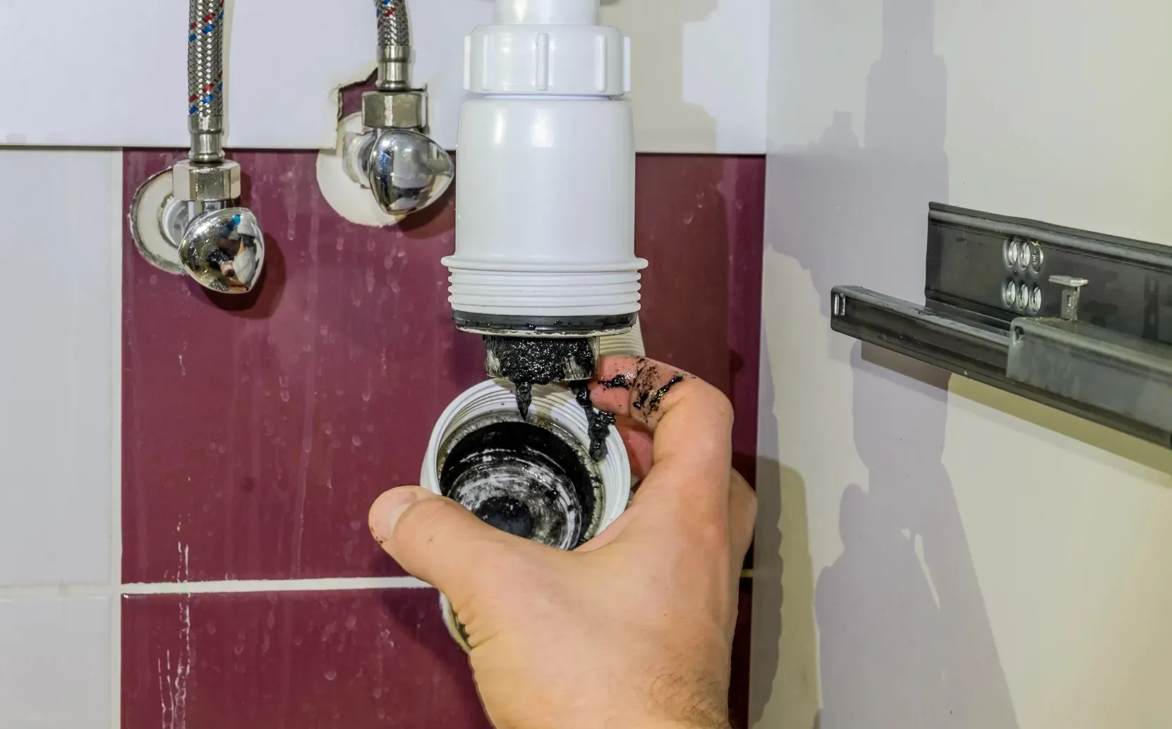 Plumber performing a video camera inspection inside a residential sewer line to diagnose drainage problems.