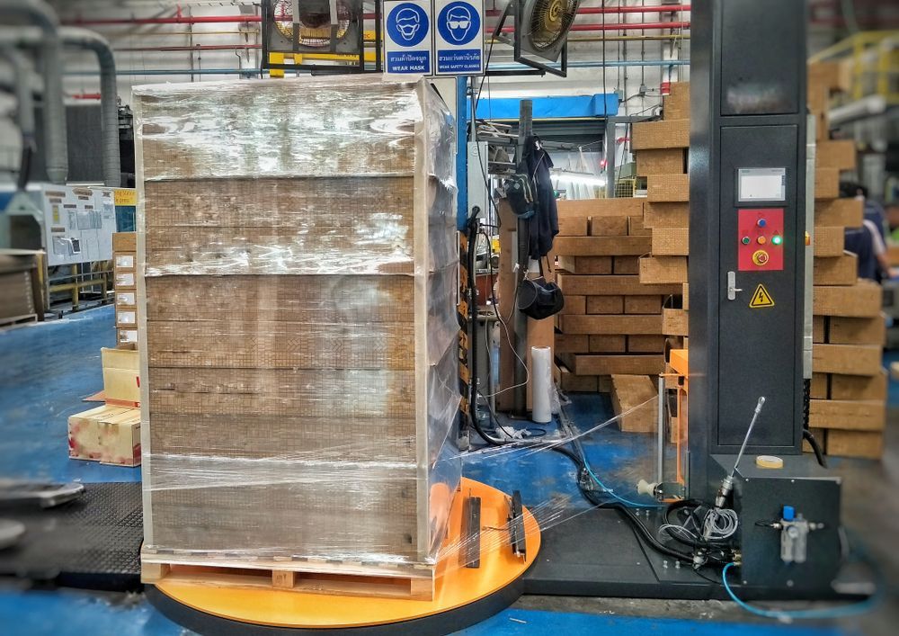 Pallet Wrapped in Clear Plastic on a Rotating Machine in a Factory — JR Removals Mackay in Dysart, QLD