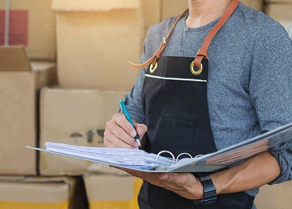 Person in Writing on a Clipboard — JR Removals Mackay in Bucasia, QLD