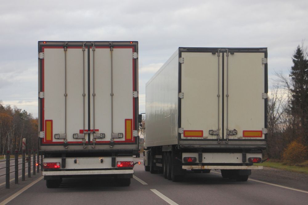 Two White Semi-truck Trailers on a Road — JR Removals Mackay in Bucasia, QLD