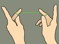 Two hands making a finger heart gesture, with green bands on the index fingers, against a gray background.