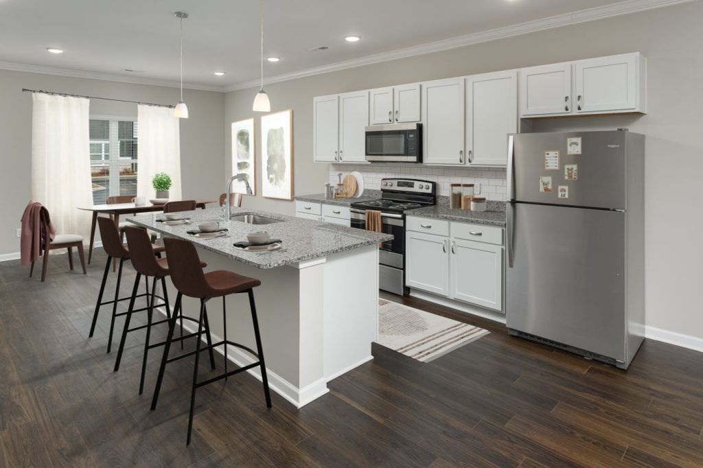 An artist 's impression of a kitchen with white cabinets and stainless steel appliances.