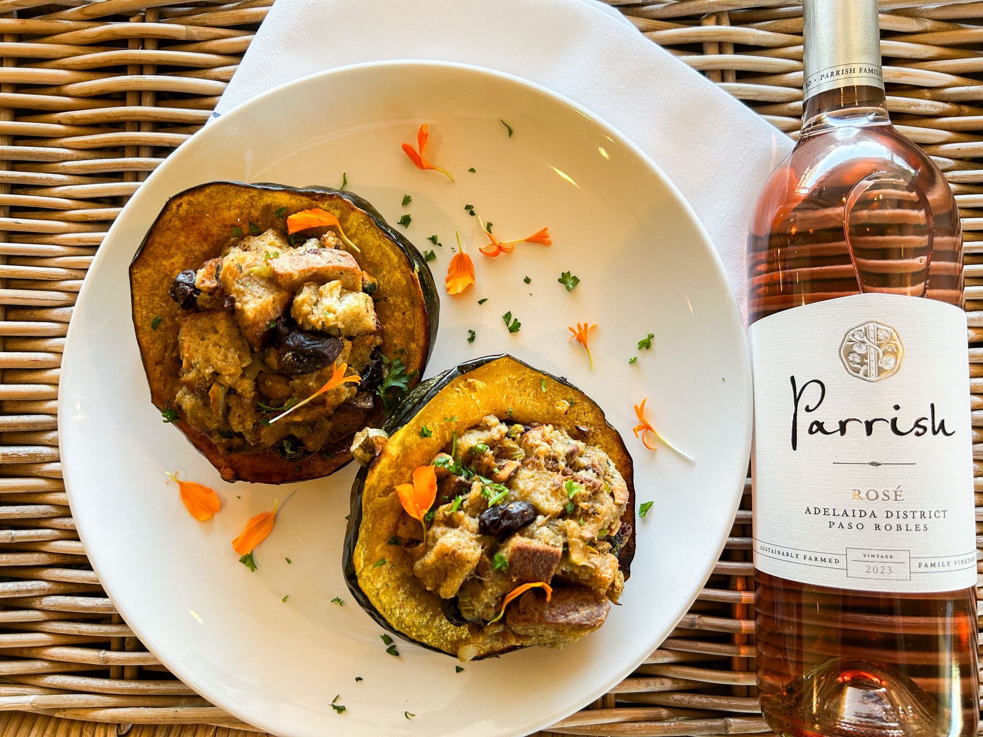 A bottle of Parrish wine next to a plate of food.