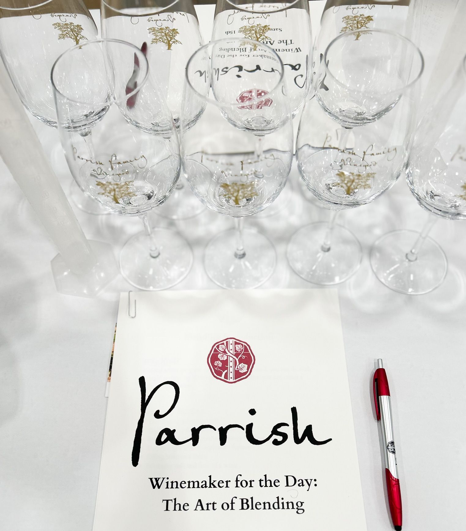 Wine glasses arranged on a table above a Parrish special event guide.