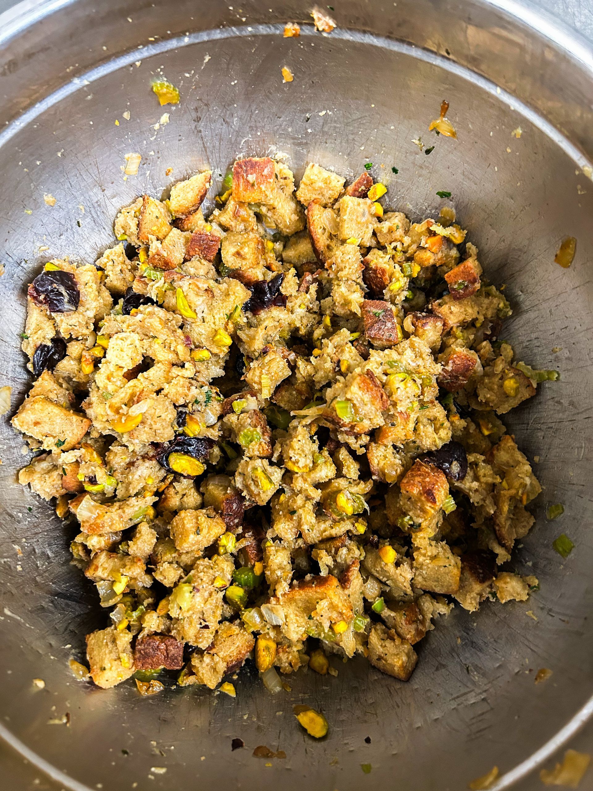 A close up of a bowl of stuffing on a table.