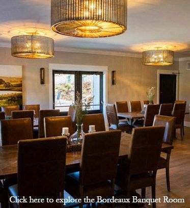 A dining room with tables and chairs.