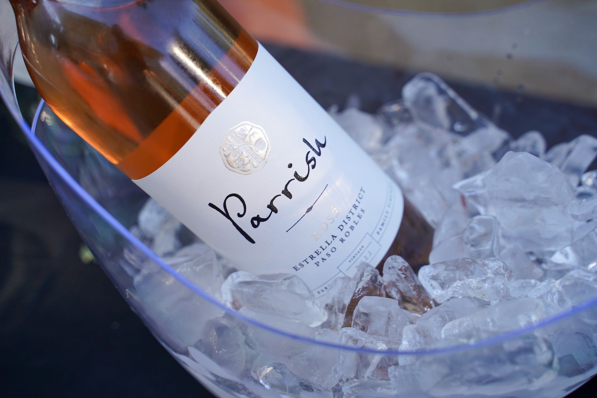 A bottle of parrish wine is in a bucket of ice