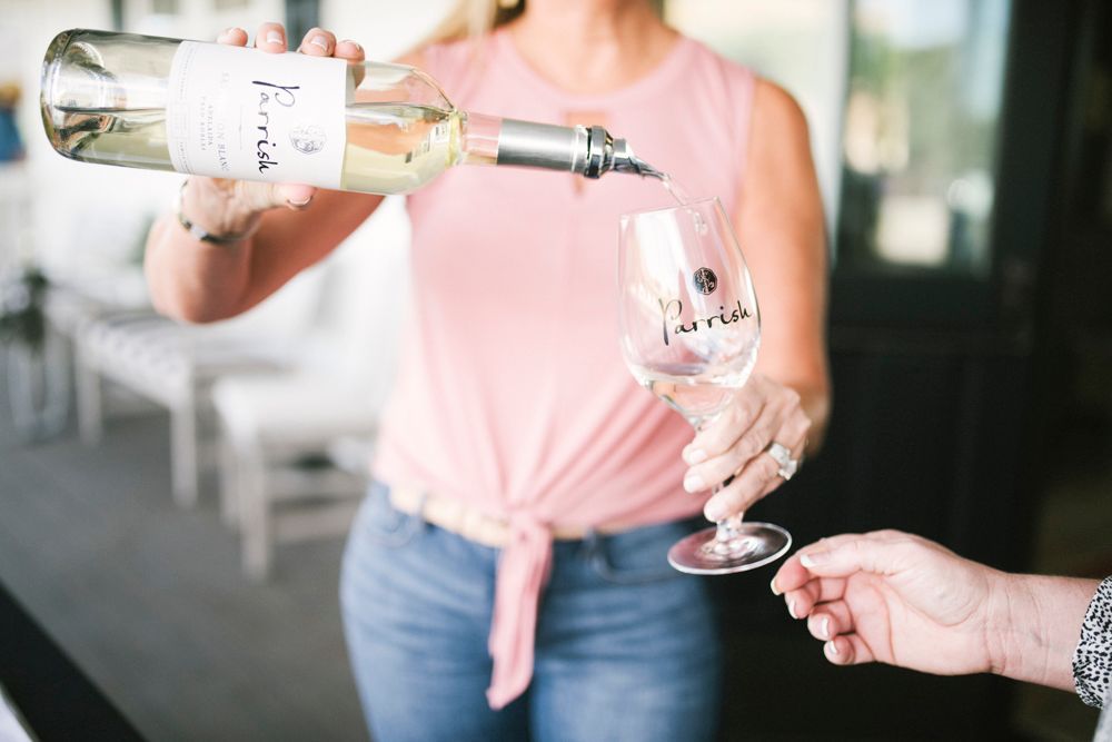 Sauvignon Blanc being poured by a server into a Parrish wine glass.