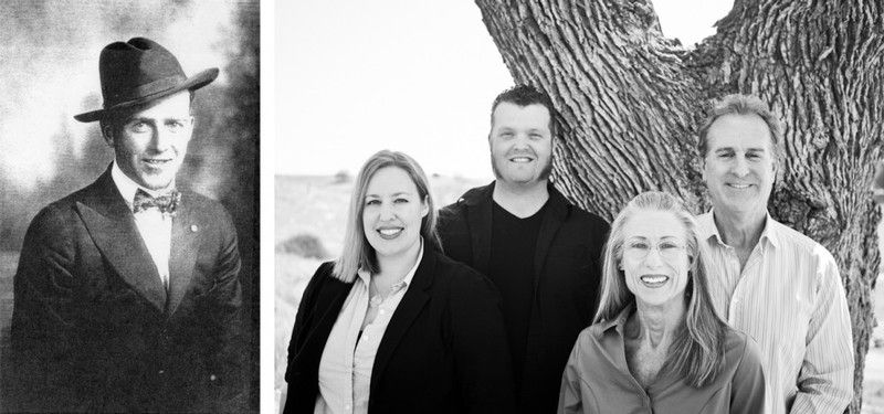 A black and white photo of a man and a group of people standing next to a tree.