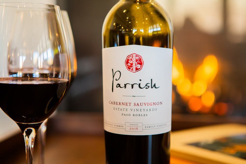A label on a bottle of a Paso Robles Cabernet Sauvignon in front of a fireplace.