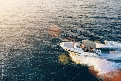 An aerial view of a boat floating on top of a body of water.