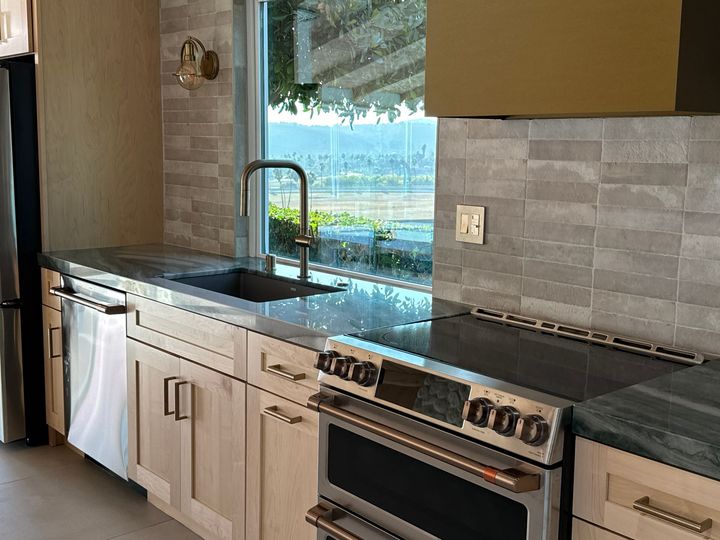 Custom kitchen with professional range, wood cabinetry and ocean view in Encinitas