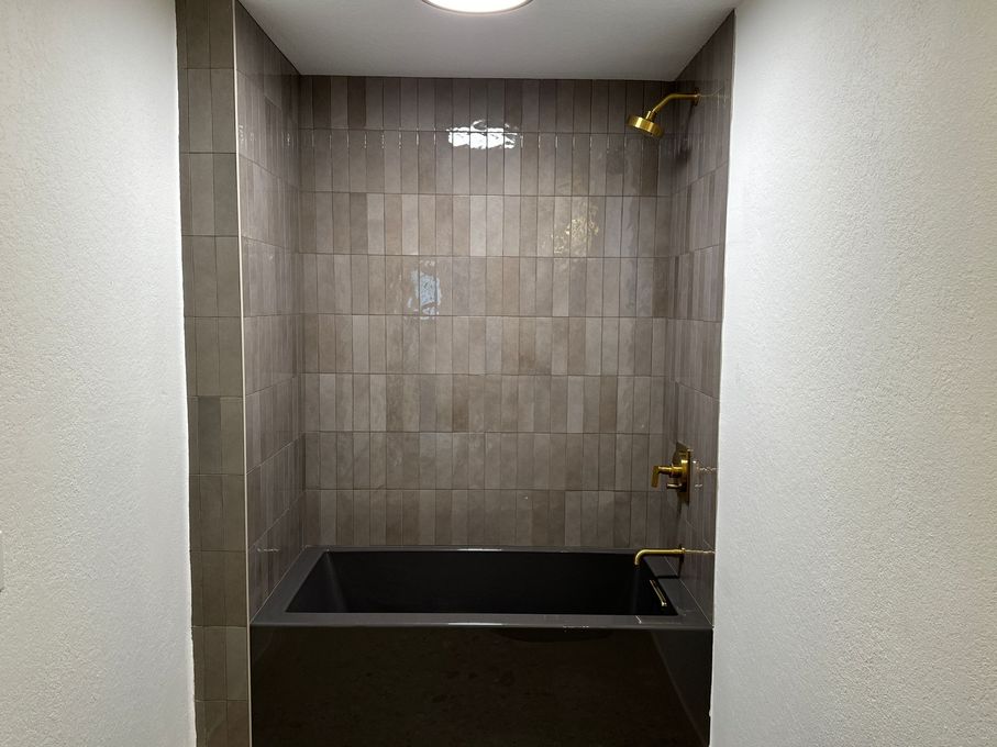 Walk-in shower remodel with dark textured tile in La Jolla