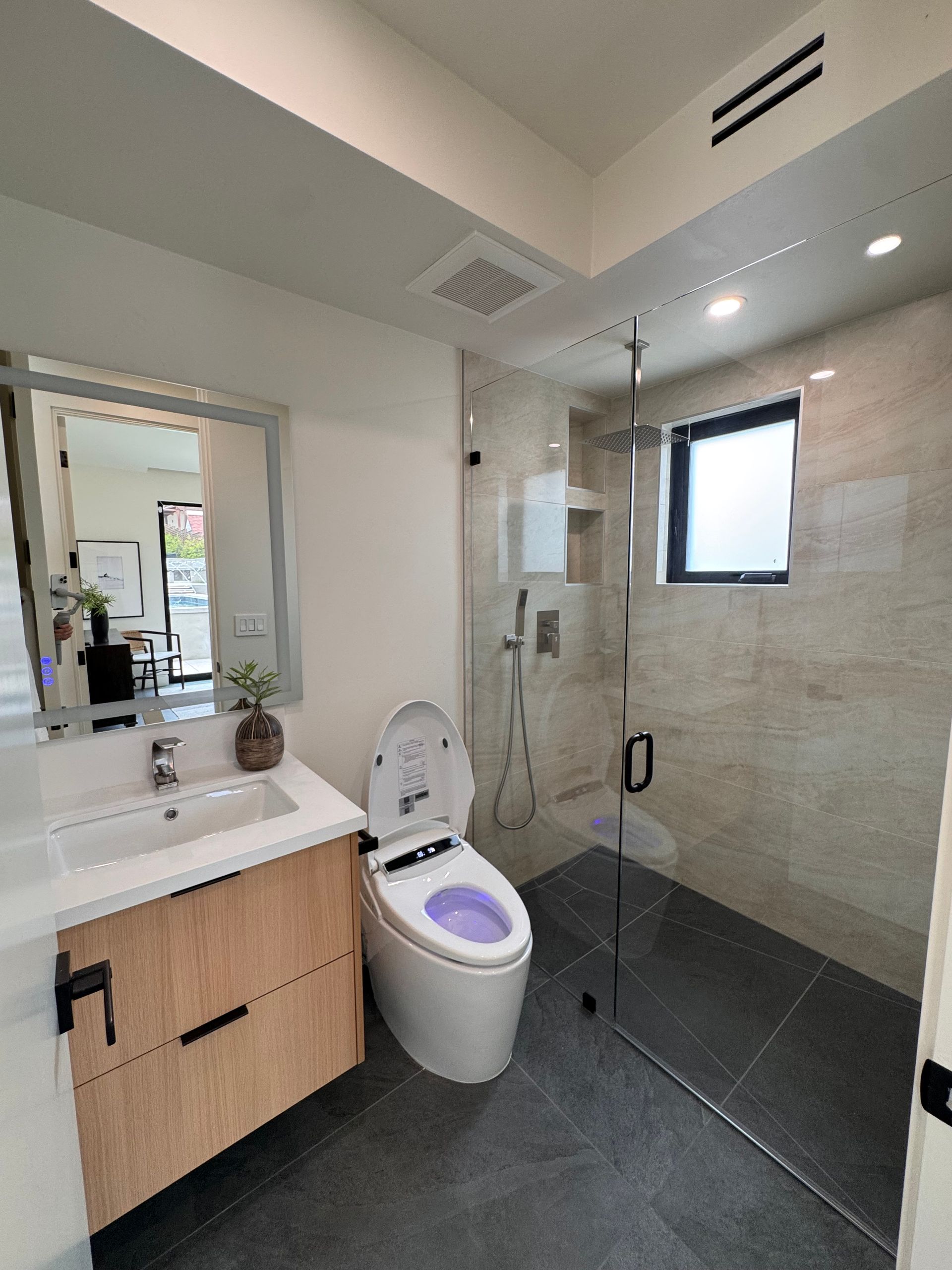 Modern kitchen renovation with white cabinets and recessed lighting in Carlsbad
