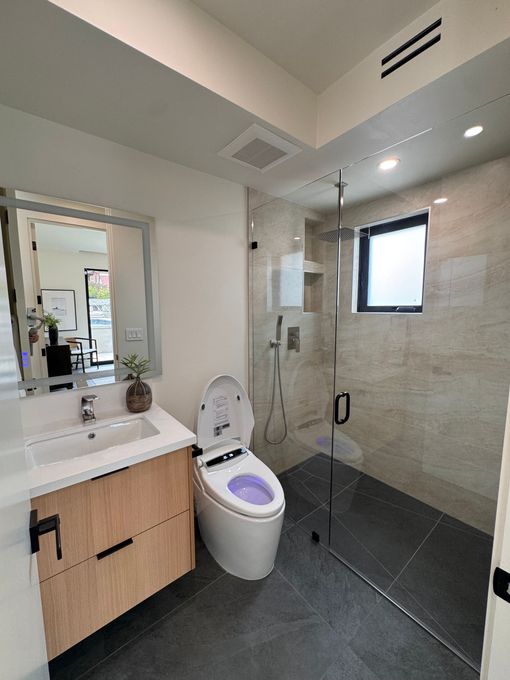 Modern kitchen renovation with white cabinets and recessed lighting in Carlsbad