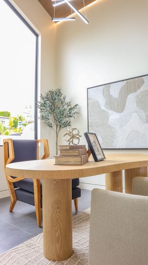 Modern dining area with wood table and natural light in Solana Beach