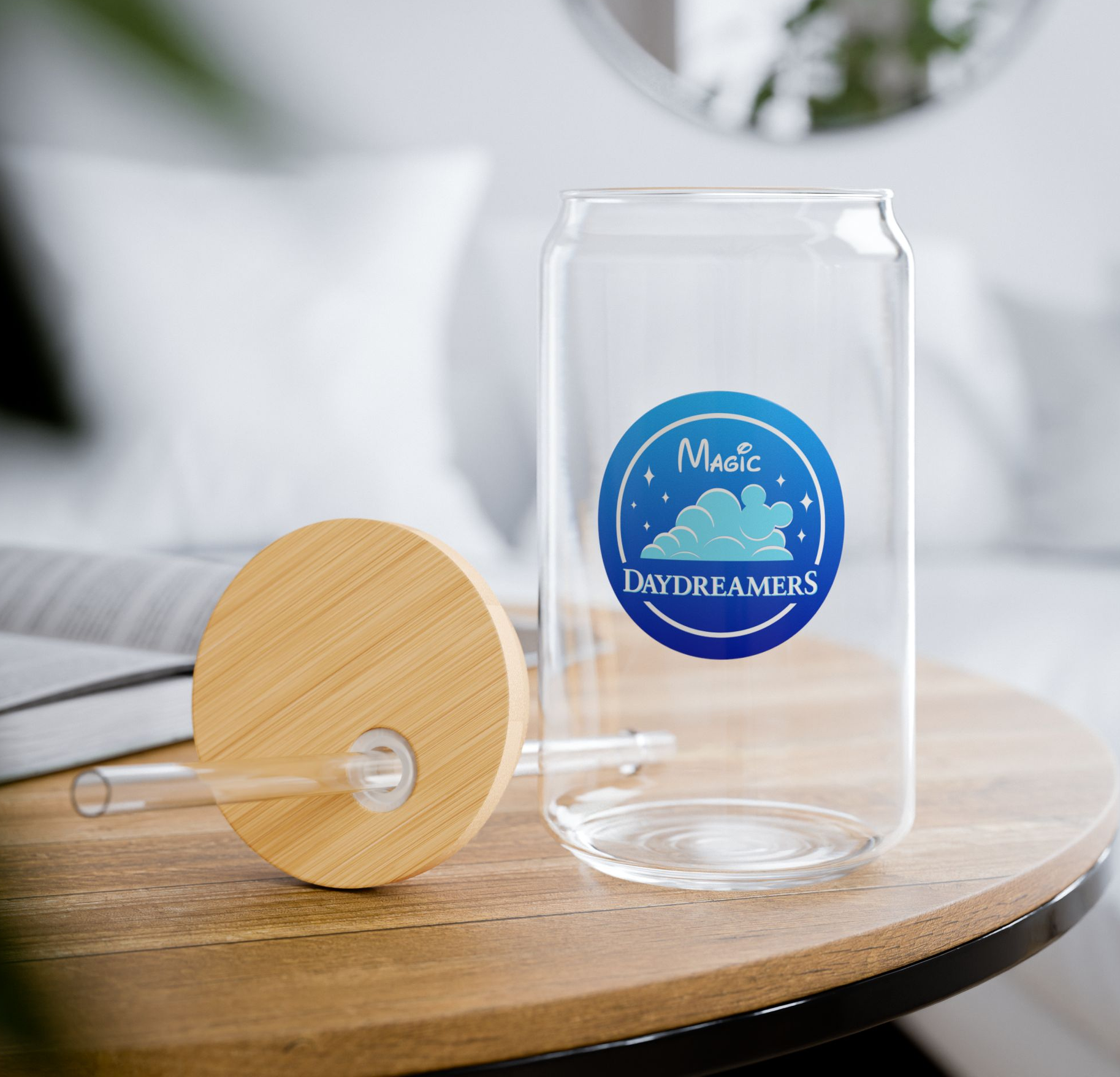 A glass can with a bamboo lid and straw on a wooden table magic daydreamers merch
