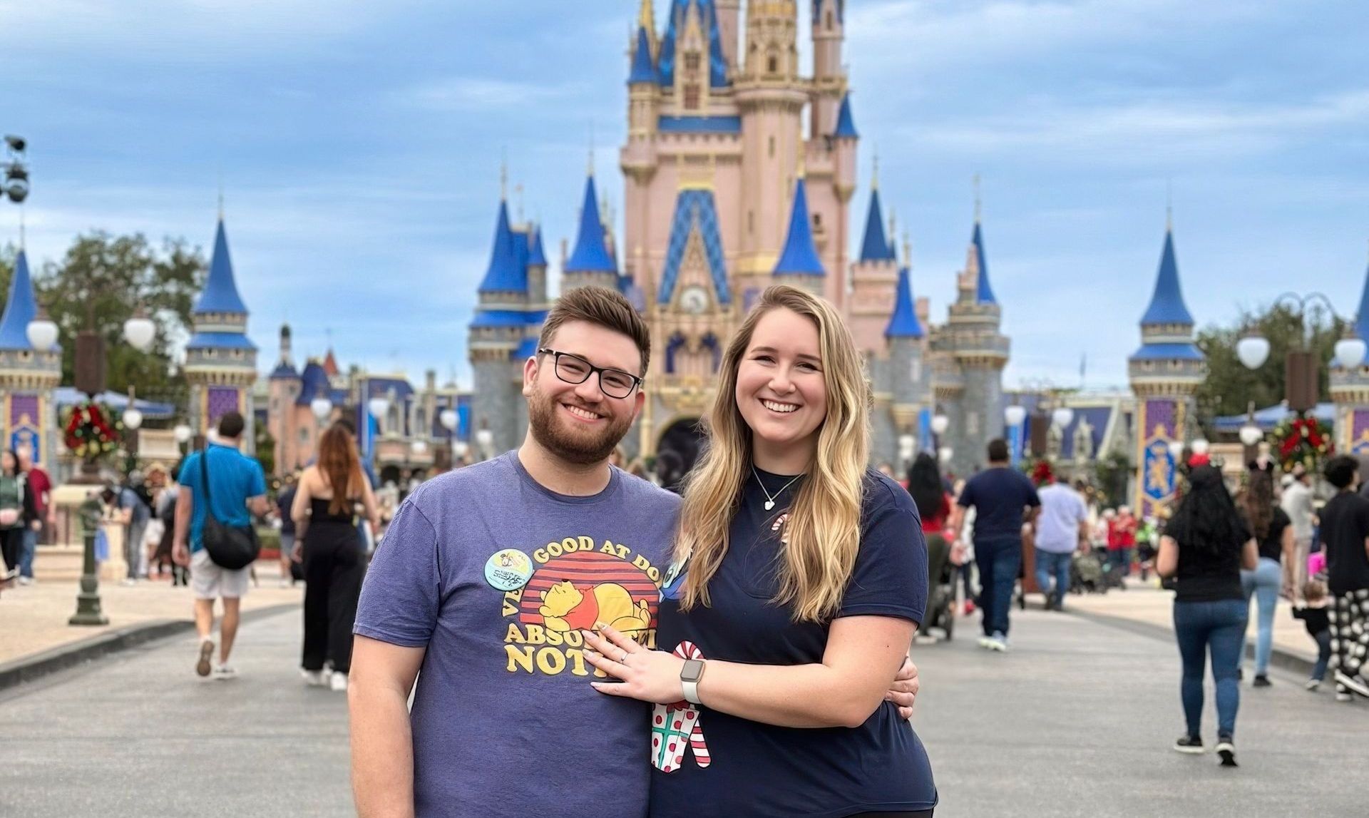 Disney influencer couple standing in front of Cinderella's castle at Magic Kingdom in Disney World