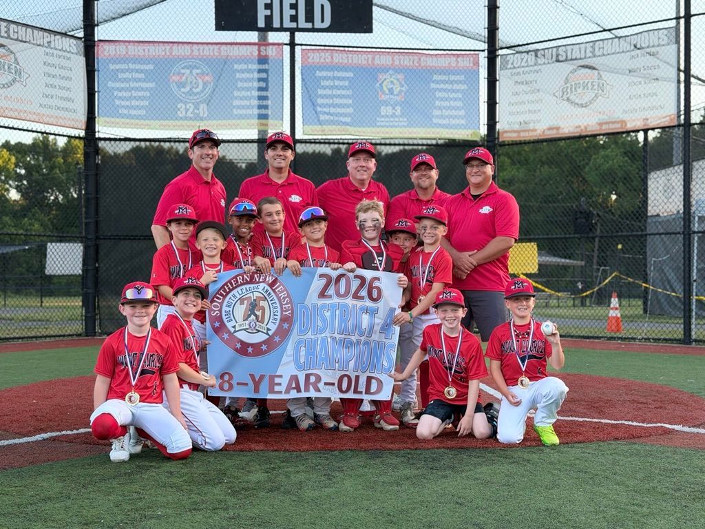Youth baseball team celebrating on a field, with one child holding a bat and others clapping and cheering.