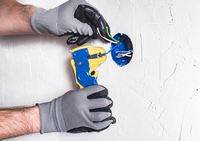 Man With Gloves Fixing Wires – Lakemba, NSW – Sparky’s Electrical