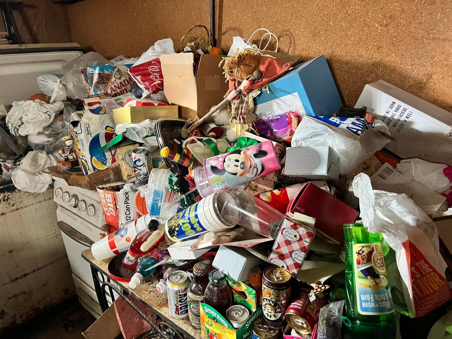 Overflowing trash bins and scattered garbage piled high in a cluttered outdoor area