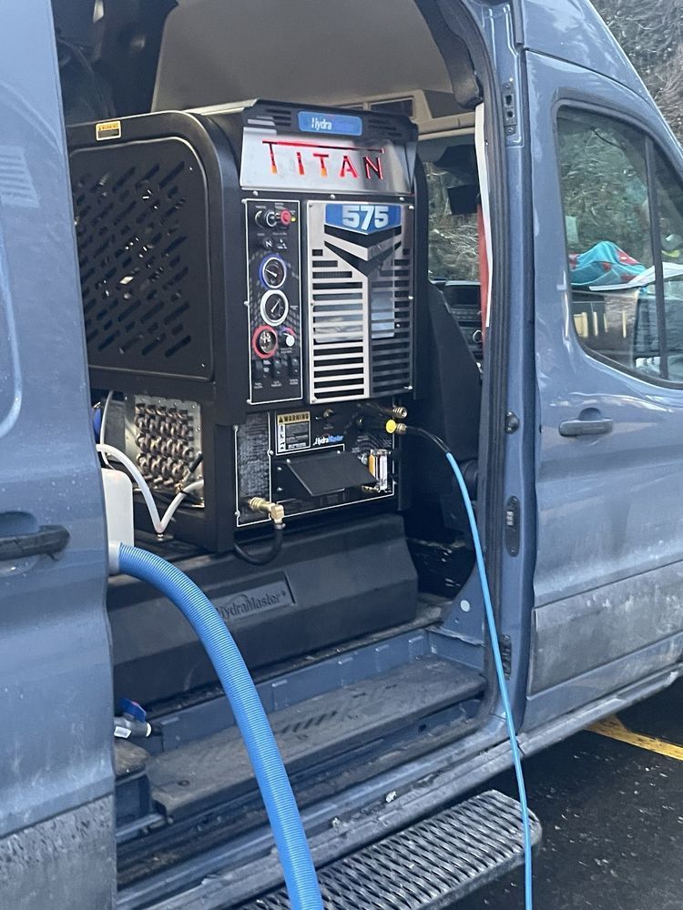 Portable Titan machine mounted in a van cargo area, with hoses and cables attached.