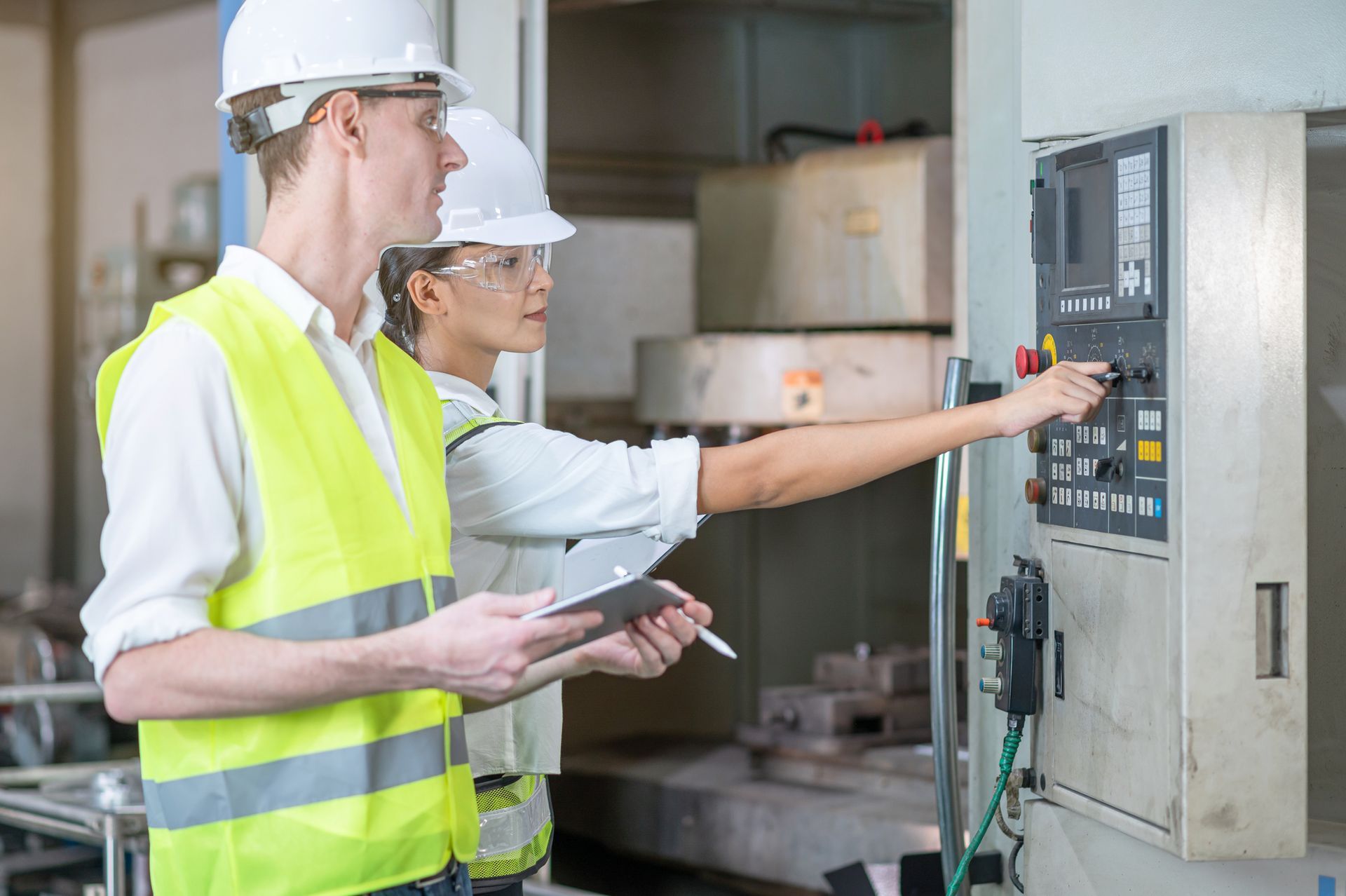 Commercial electric contractor and engineer checking control panel inside industrial facility. Commercial electric contractor and engineer checking control panel inside industrial facility.