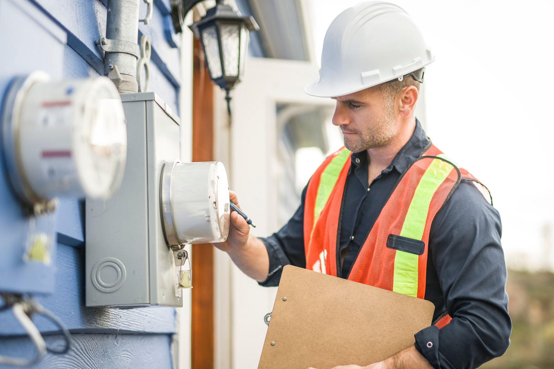 Man with hard hat standing in front of a electric panel. Man with hard hat standing in front of a electric panel.