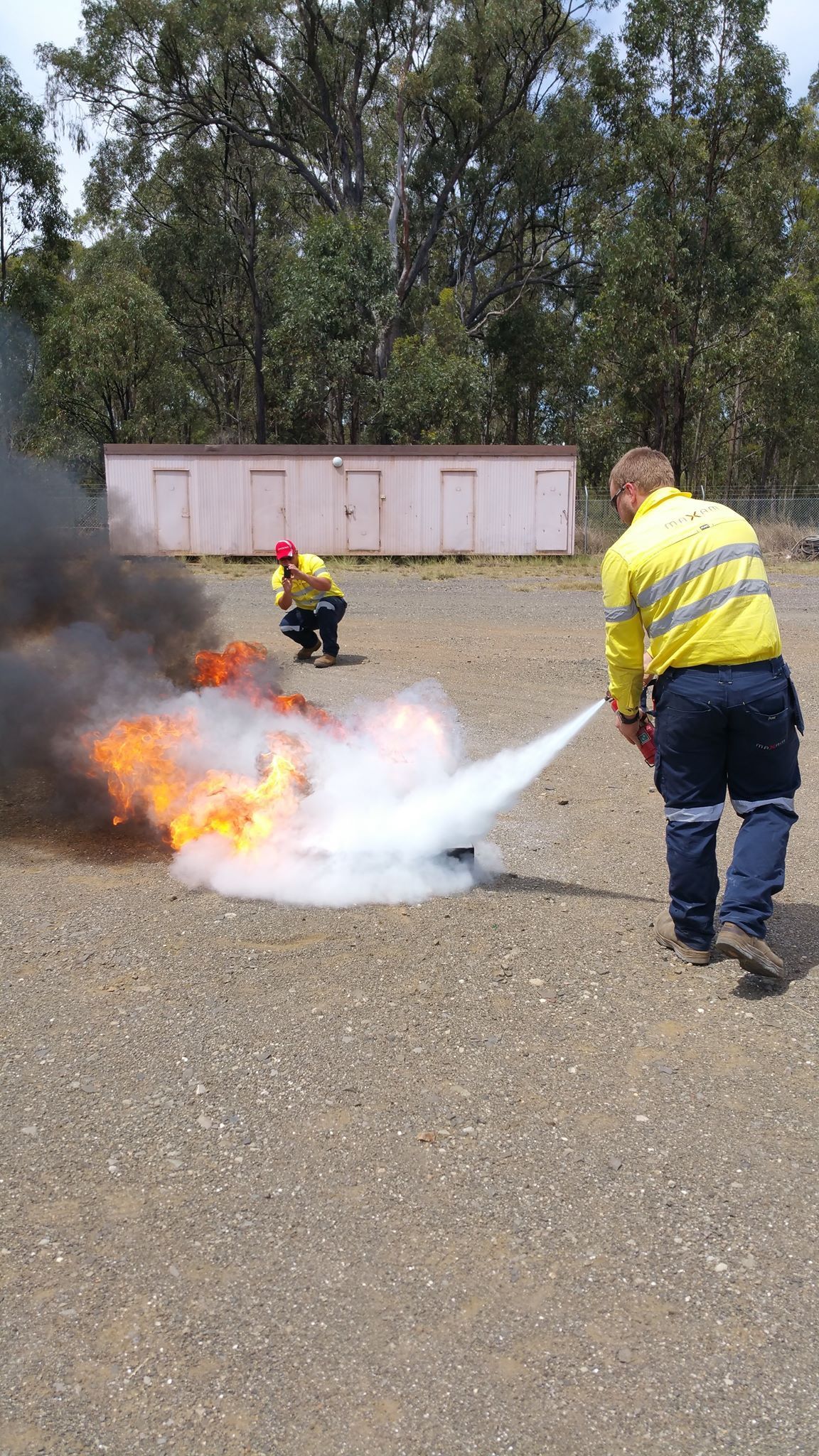 Firefighters Spraying Water on a Small Ground Fire — CSET Group Fire & Security in Sydney, NSW
