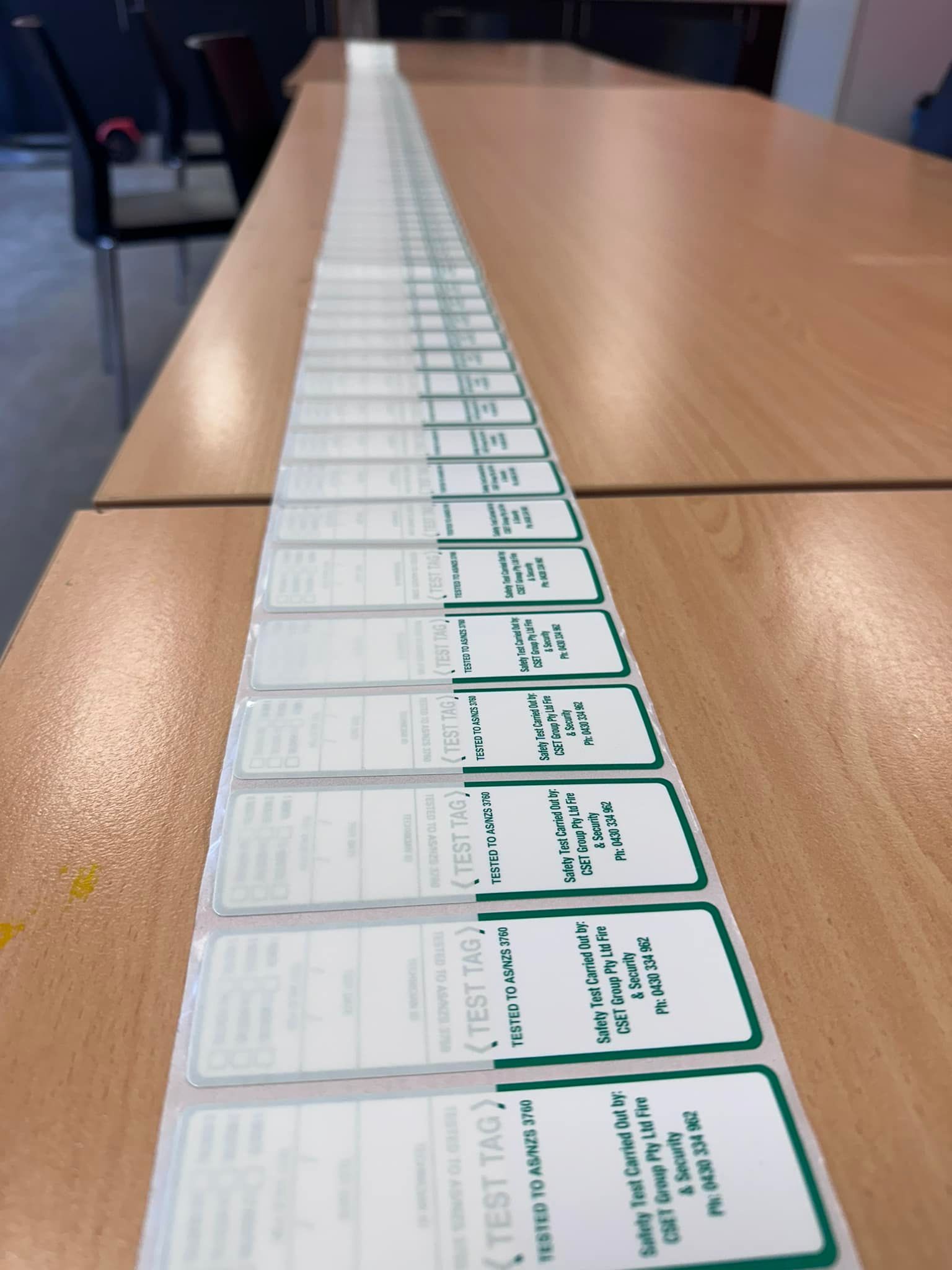 Rows of Green-and-white Cards Lined Up on a Wooden Conference Table — CSET Group Fire & Security in Sydney, NSW