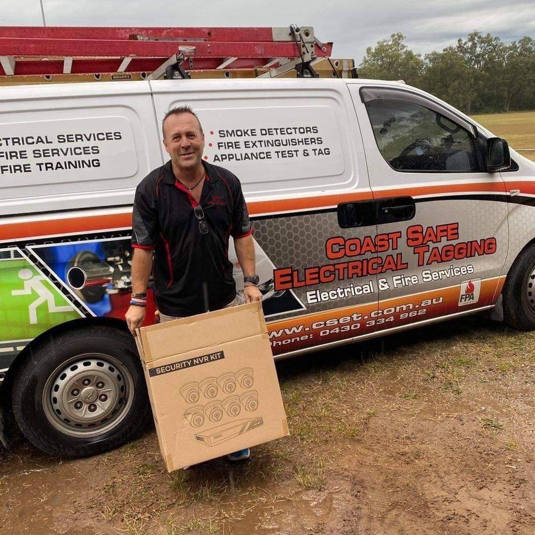 MAN Standing Beside a Coast Safe Electrical & Fire Services Van — CSET Group Fire & Security in Lake Macquarie, NSW