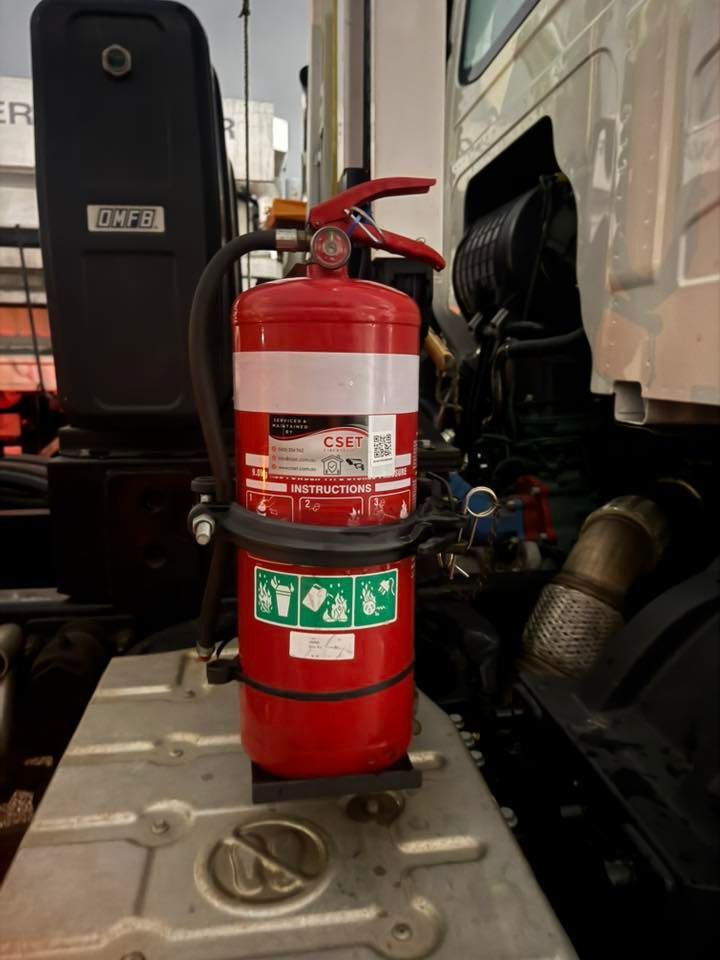 Red Fire Extinguisher Mounted on a Truck Step Beside the Cab — CSET Group Fire & Security in Hunter Valley, NSW
