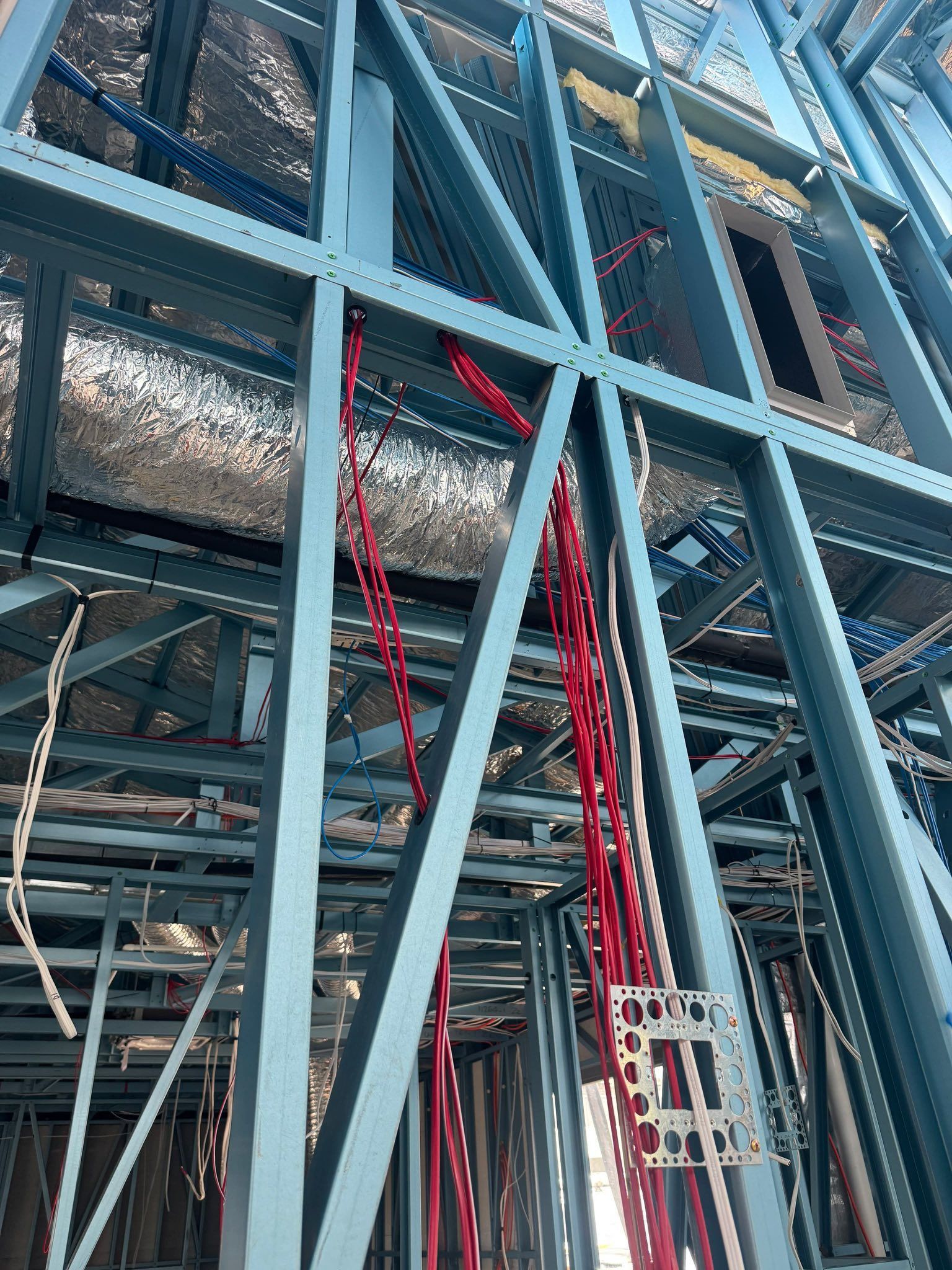 Industrial Piping Inside a Large Metal Structure With Red Cables Hanging Down — CSET Group Fire & Security in Sydney, NSW