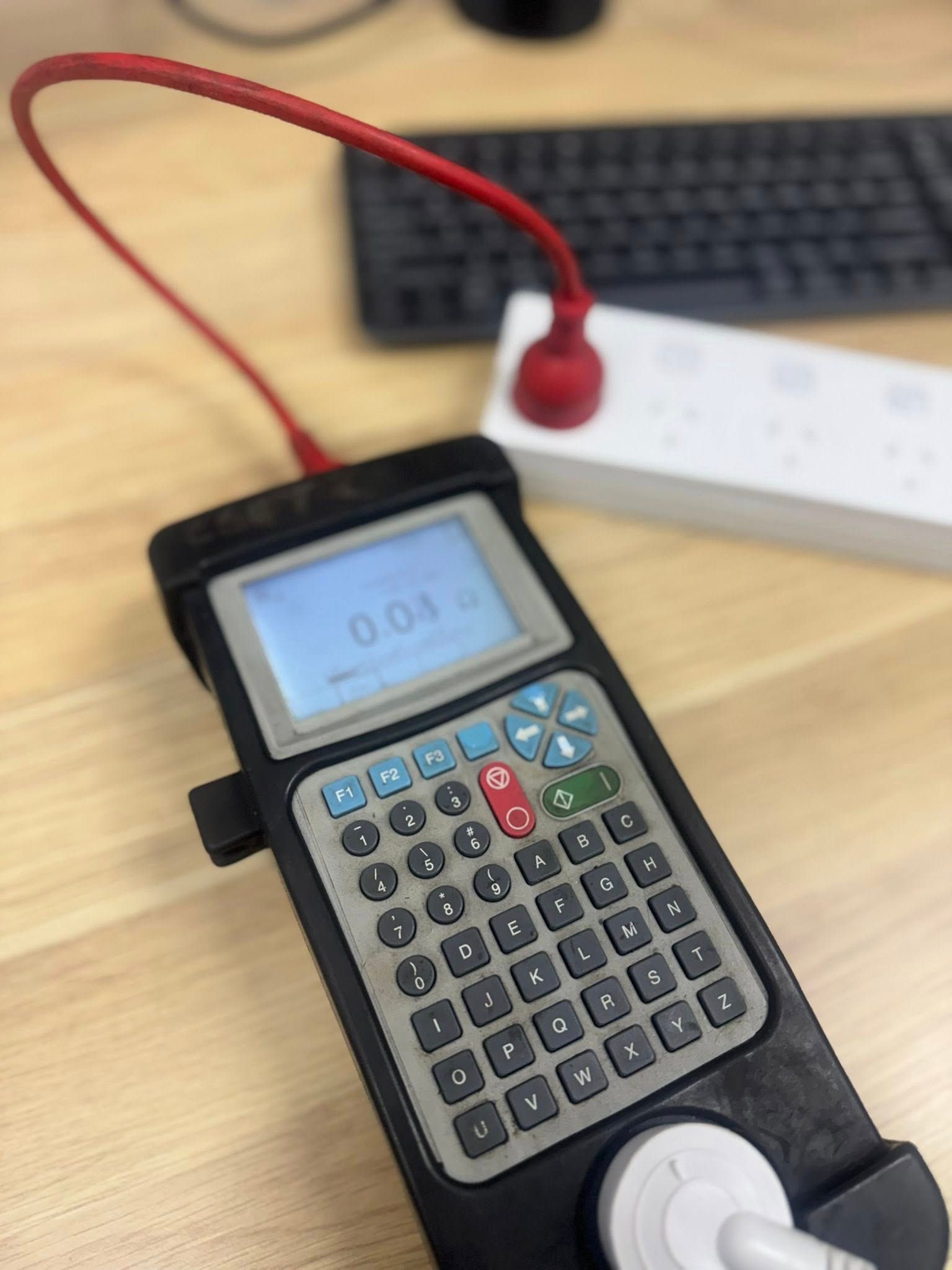 Handheld Electronic Device With a Keypad and Screen on a Desk — CSET Group Fire & Security in Lake Macquarie, NSW