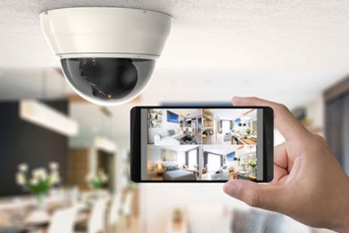 Hand Holding Smartphone Showing Home Security Camera Feed — CSET Group Fire & Security in Newcastle, NSW