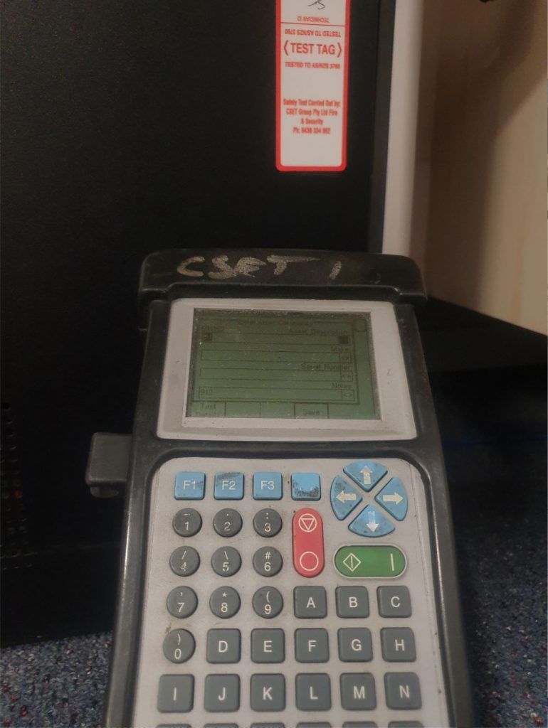Handheld Electronic Device With a Screen and Keypad on a Counter — CSET Group Fire & Security in Sydney, NSW