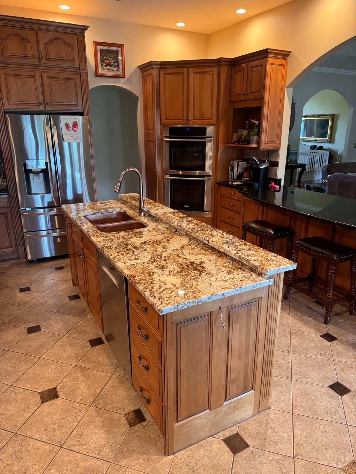 Kitchen with a large island, granite countertops, and stainless steel appliances.