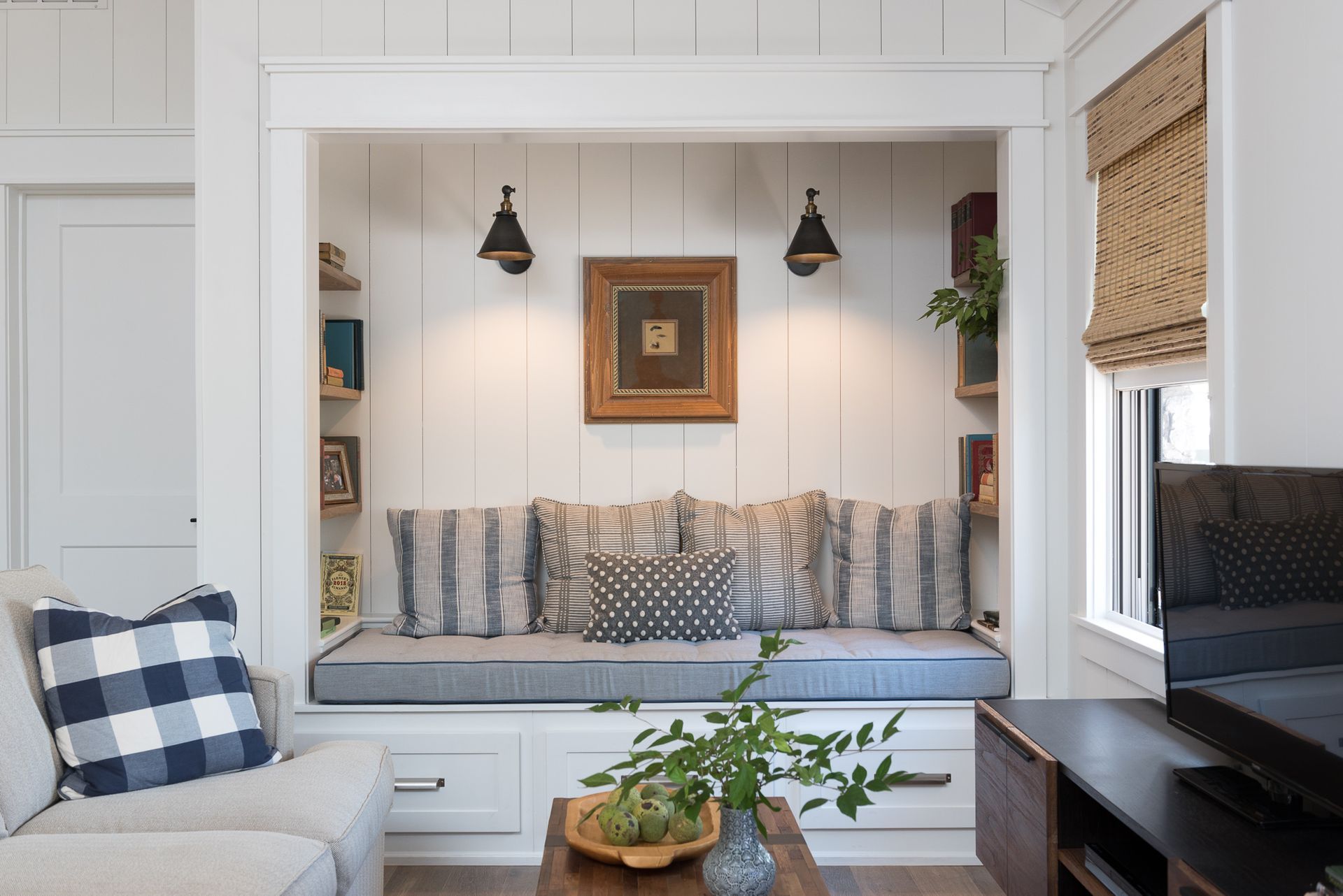 A living room with a window seat and a couch.