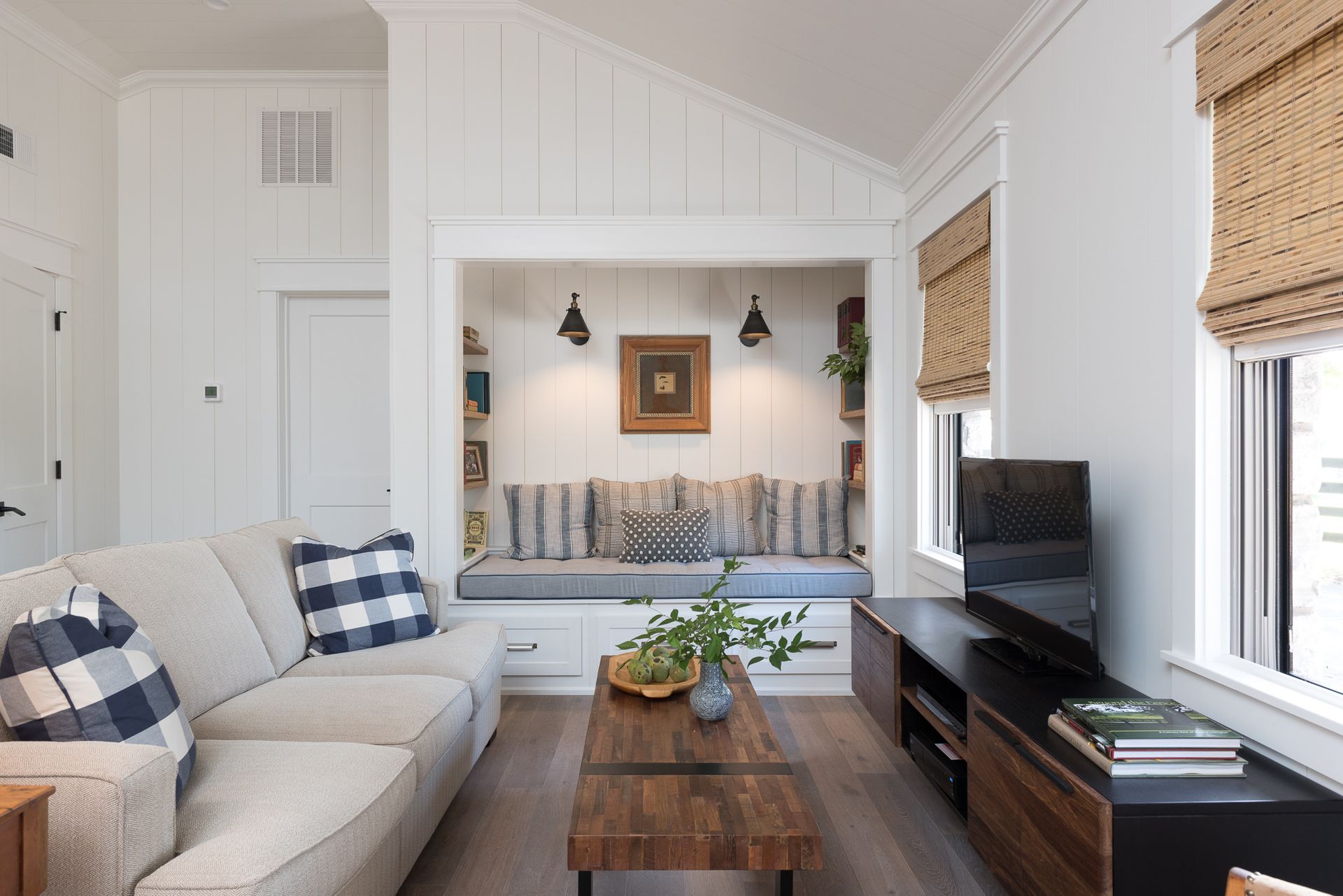 A living room with a couch , coffee table , and television.
