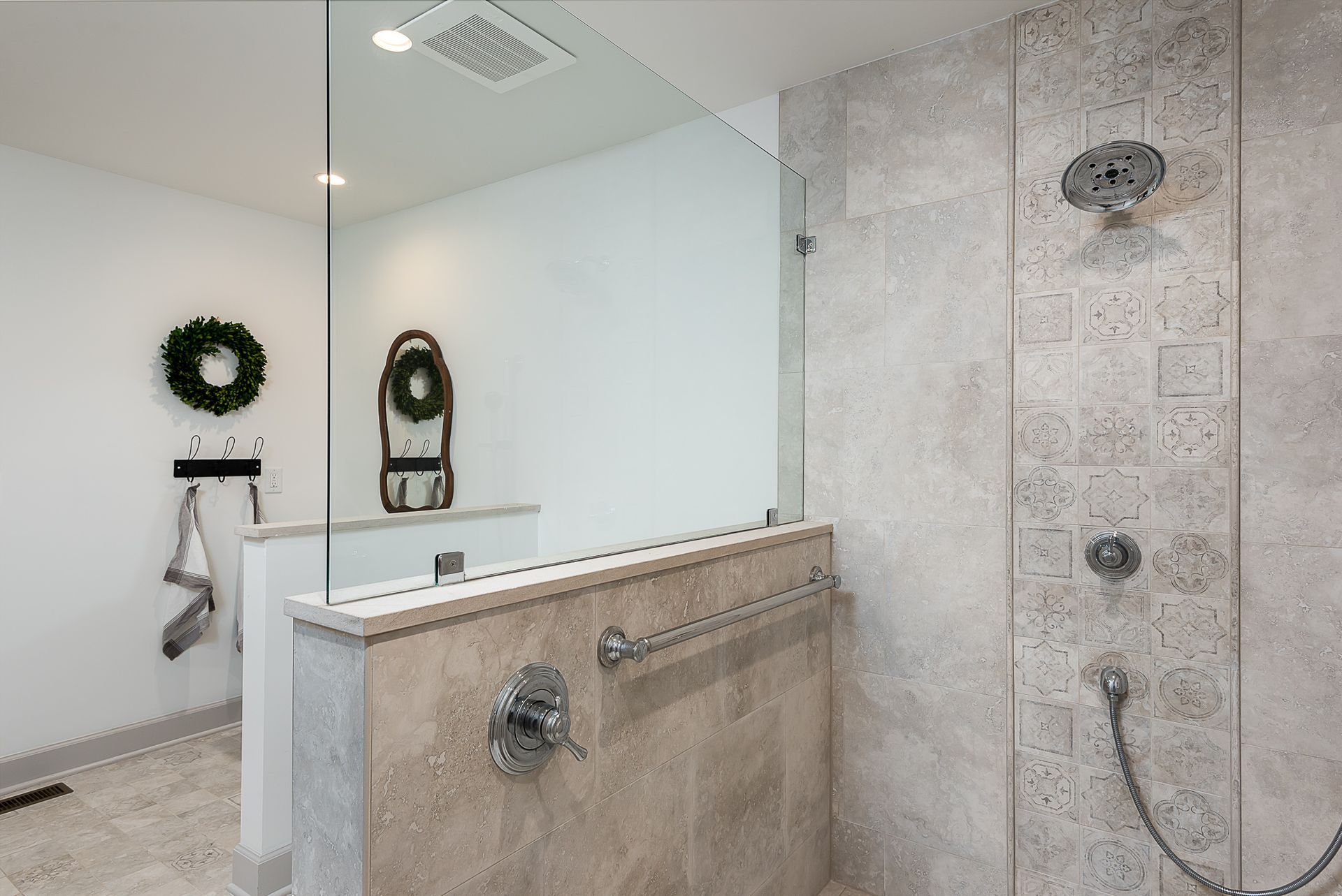A bathroom with a walk in shower and a mirror.