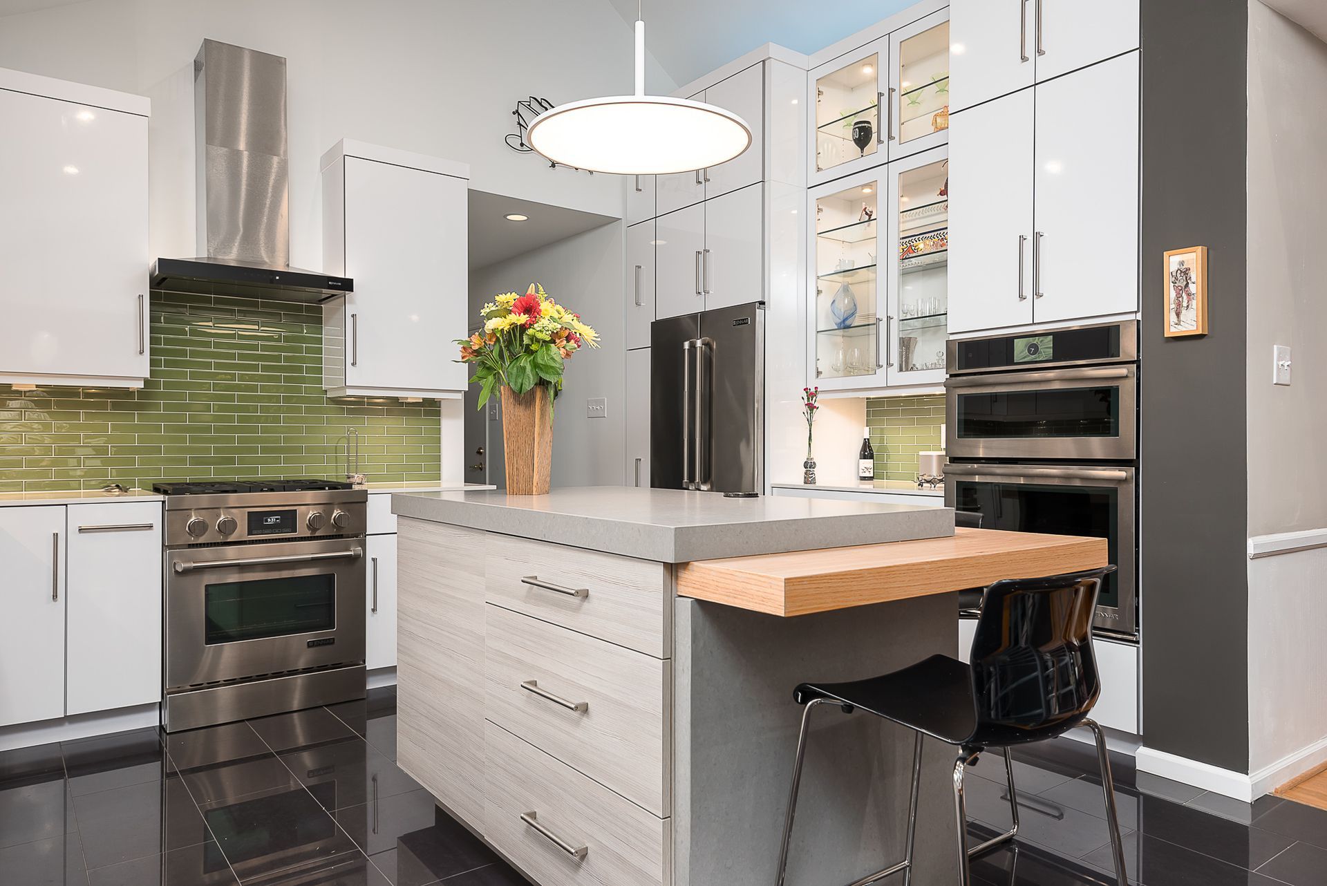 A kitchen with white cabinets and stainless steel appliances