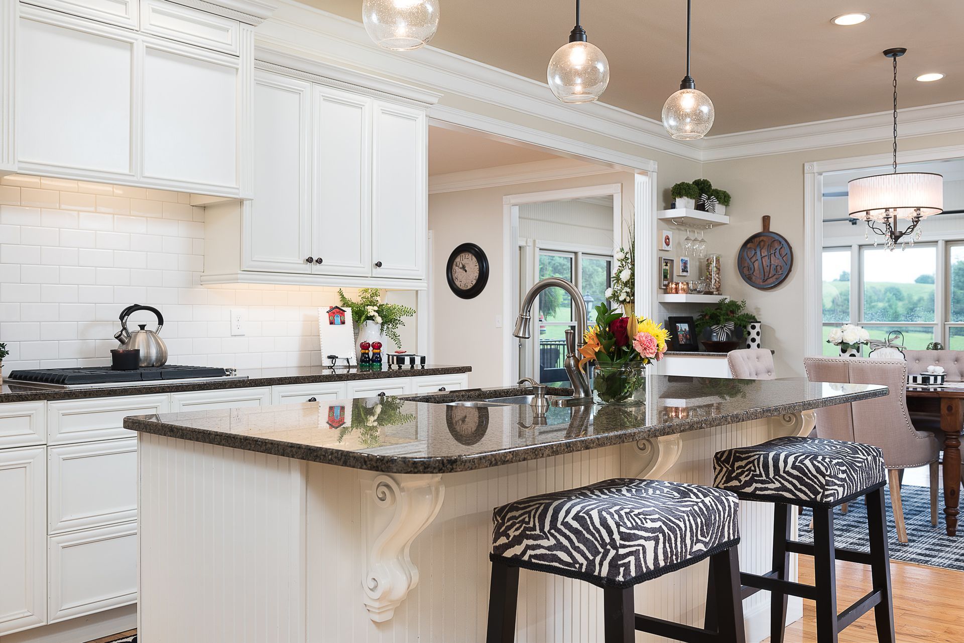 A kitchen with white cabinets and granite counter tops