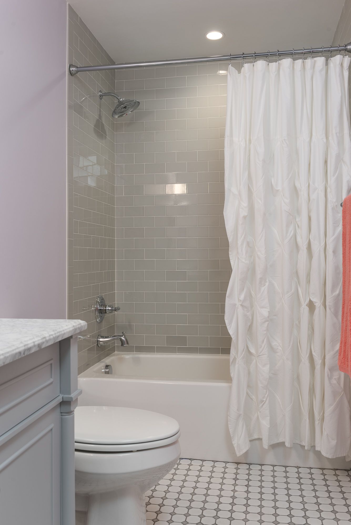 A bathroom with a toilet , bathtub and shower curtain.